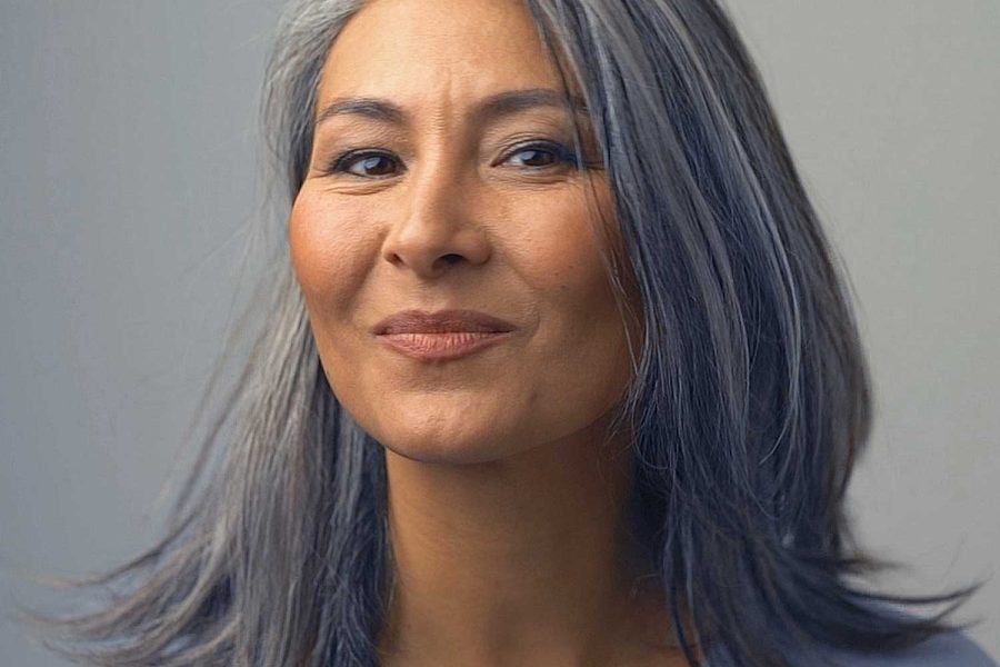 Woman with grey hair smiling.
